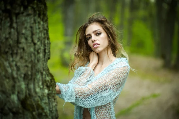 Sensual woman in forest