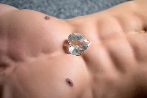 Muscular torso with heart gemstone