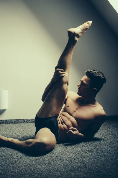 Muscular man with raised leg
