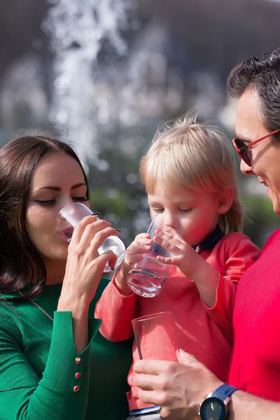 Young family with water glasses