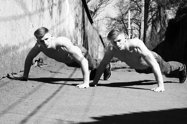 Twin brothers do push-ups