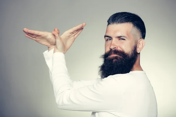 Bearded man with hands in bird shape