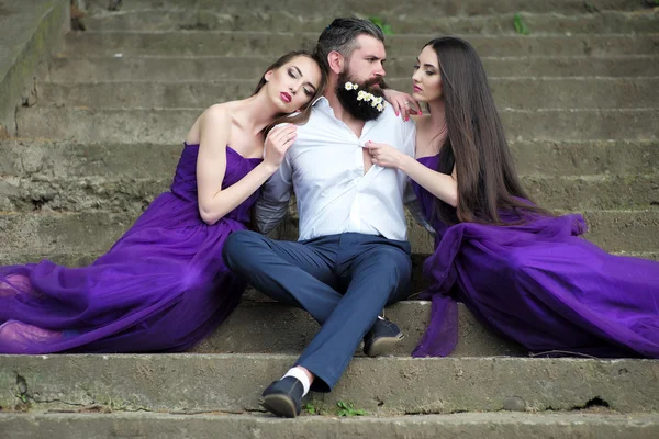 Bearded man and women on stairs