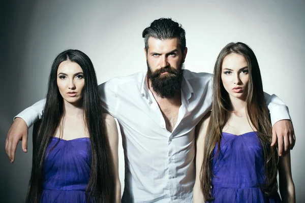 Bearded man and two women