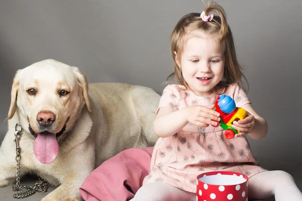 Little girl with labrador dog