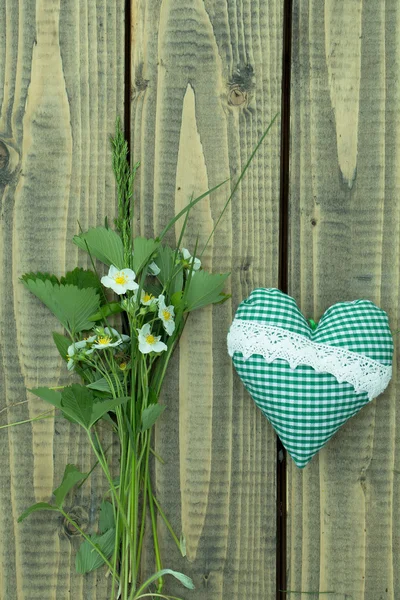 Floral arrangement with heart pillow