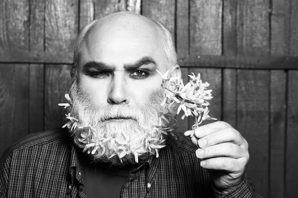 Old man with flowers in beard