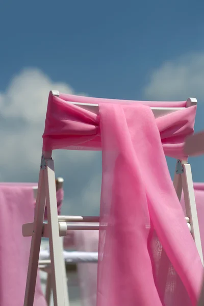 Wedding chairs with pink bows