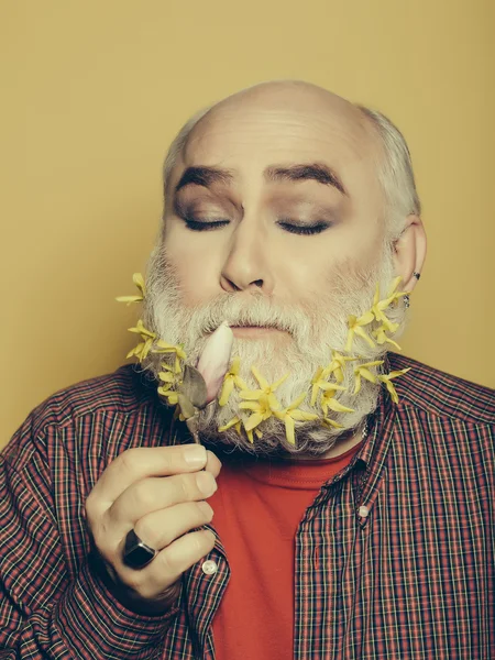 Old man with flowers and leaves in beard