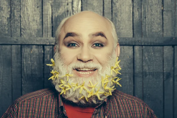 Old man with flowers in beard