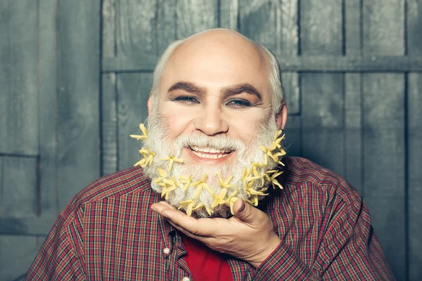 Old man with flowers in beard