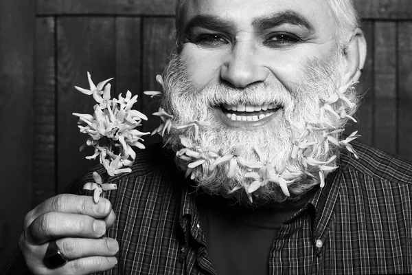 Old man with flowers in beard