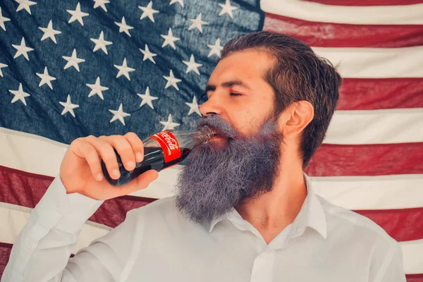 Independence day man with flag and coca cola