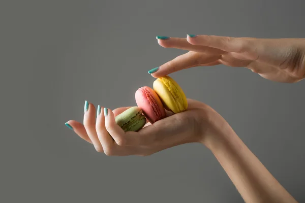 Female hands with macaron