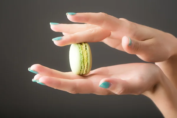 Female hands with macaron