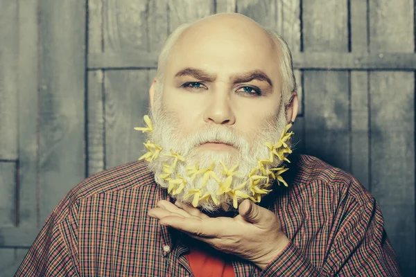 Old man with flowers in beard