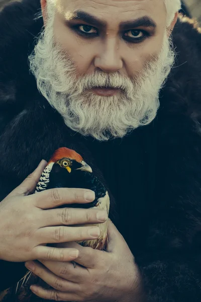 Bearded man with pheasant