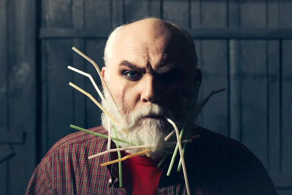 Old man with drinking straws in beard