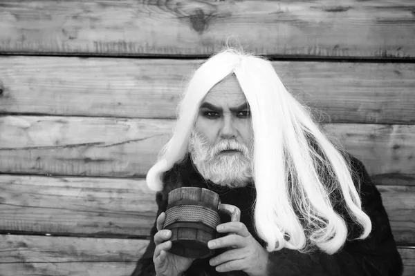 Bearded man with wooden mug