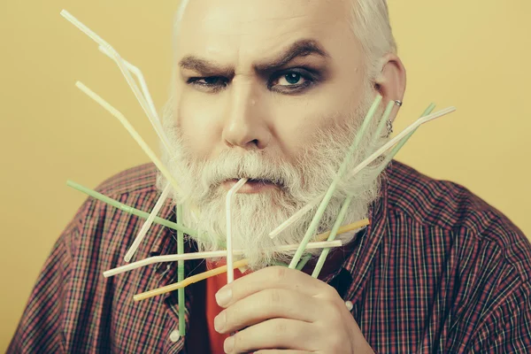 Old man with drinking straws in beard