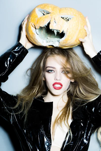 Pretty woman with halloween pumpkin
