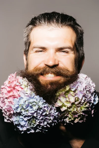 Bearded man with hydrangea flowers