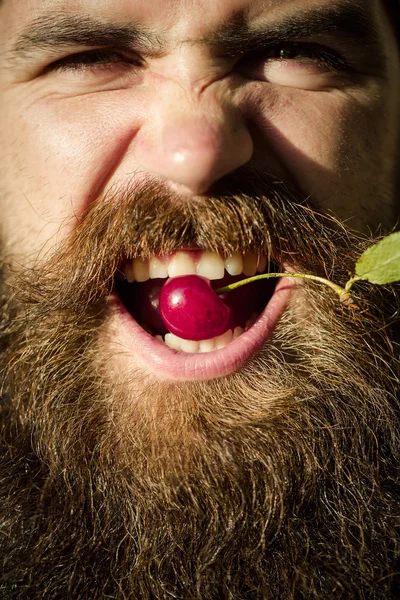 Bearded man with red cherry