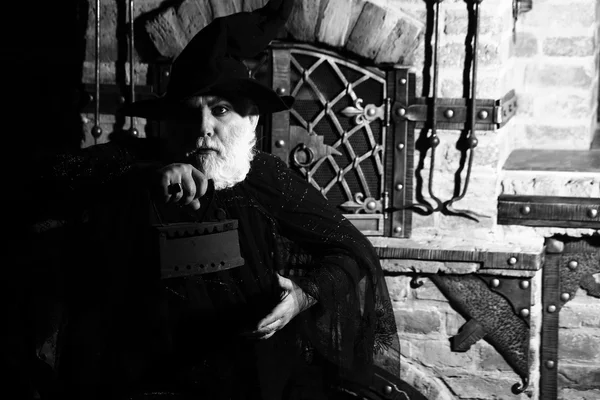 Old wizard with coal iron
