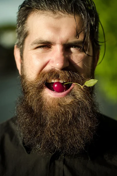 Bearded man with red cherry