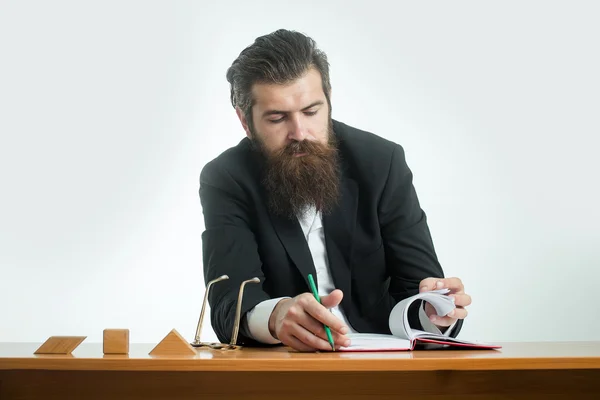 Bearded man teacher at table