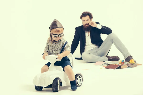 Small boy driver or pilot and bearded father