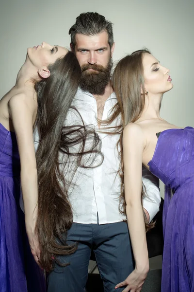 Bearded man and two women