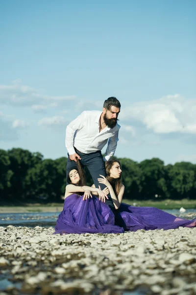 Bearded man and two women outdoor