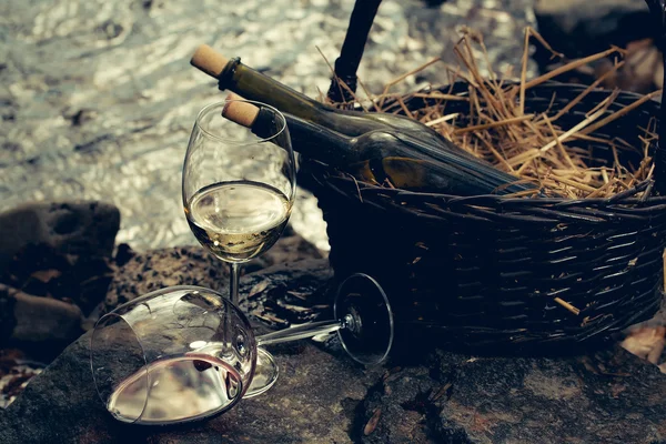 Wine glass and bottles in basket