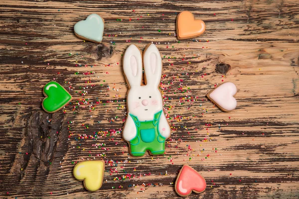 Colorful hare and heart cookies on wood