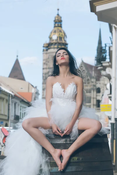 Wedding sexy woman on wooden barrel