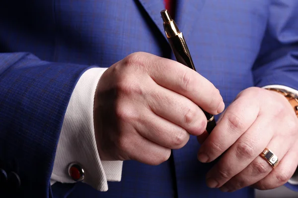 Male hands holding the pen