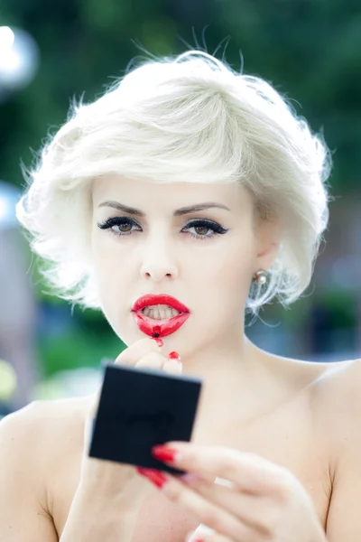 Sexy blonde put on lipstick