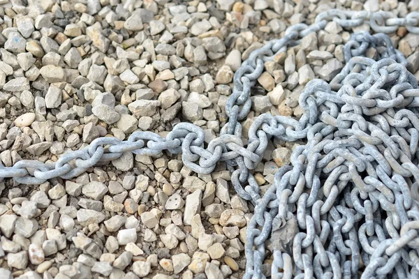 Little pebble stones and anchor chain