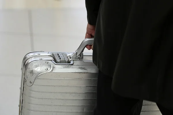Man carrying metallic security suitcase