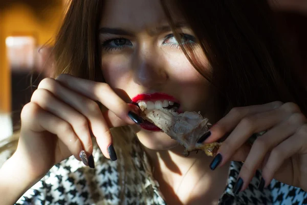 Girl eating meat