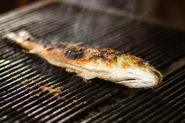 Burned fish on grill