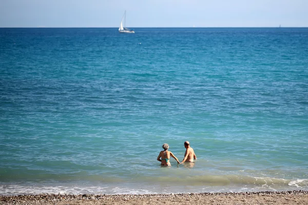 Senior couple bathing in sea