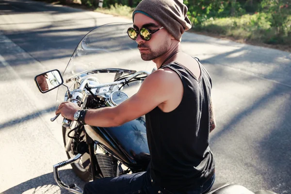 Handsome stylish man riding bike