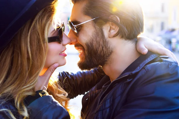 Stylish sexy couple kissing on sunset