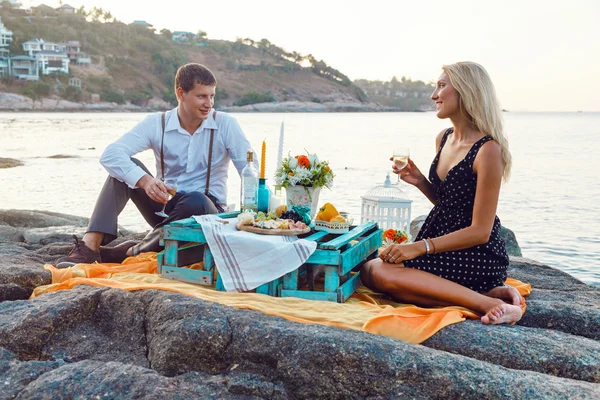 Couple enjoying picnic on the beach together