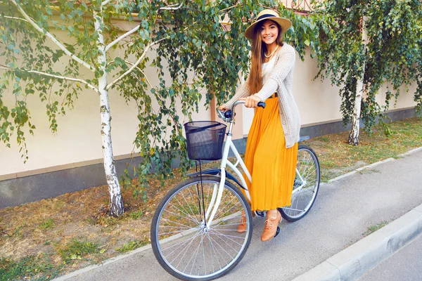 Elegant girl with hipster retro bike