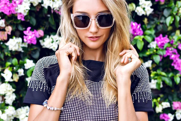 Stunning blonde young woman in sunglasses