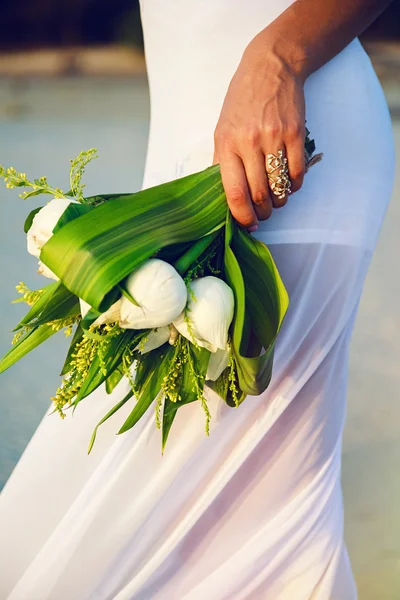 Woman with exotic wedding lotus bouquet