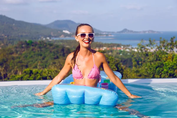 Woman in bikini having fun at pool